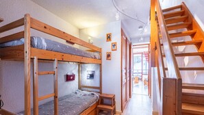 A bunk bed room with a wooden staircase and a small wooden stool. - Apartment in Morillon near Ski Slopes (Morillon)
