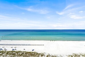 A beach with a sandy shore and a clear blue sky.