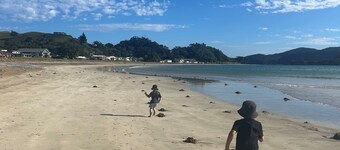 Beautifully renovated 5-bedroom bach just steps from the sand.