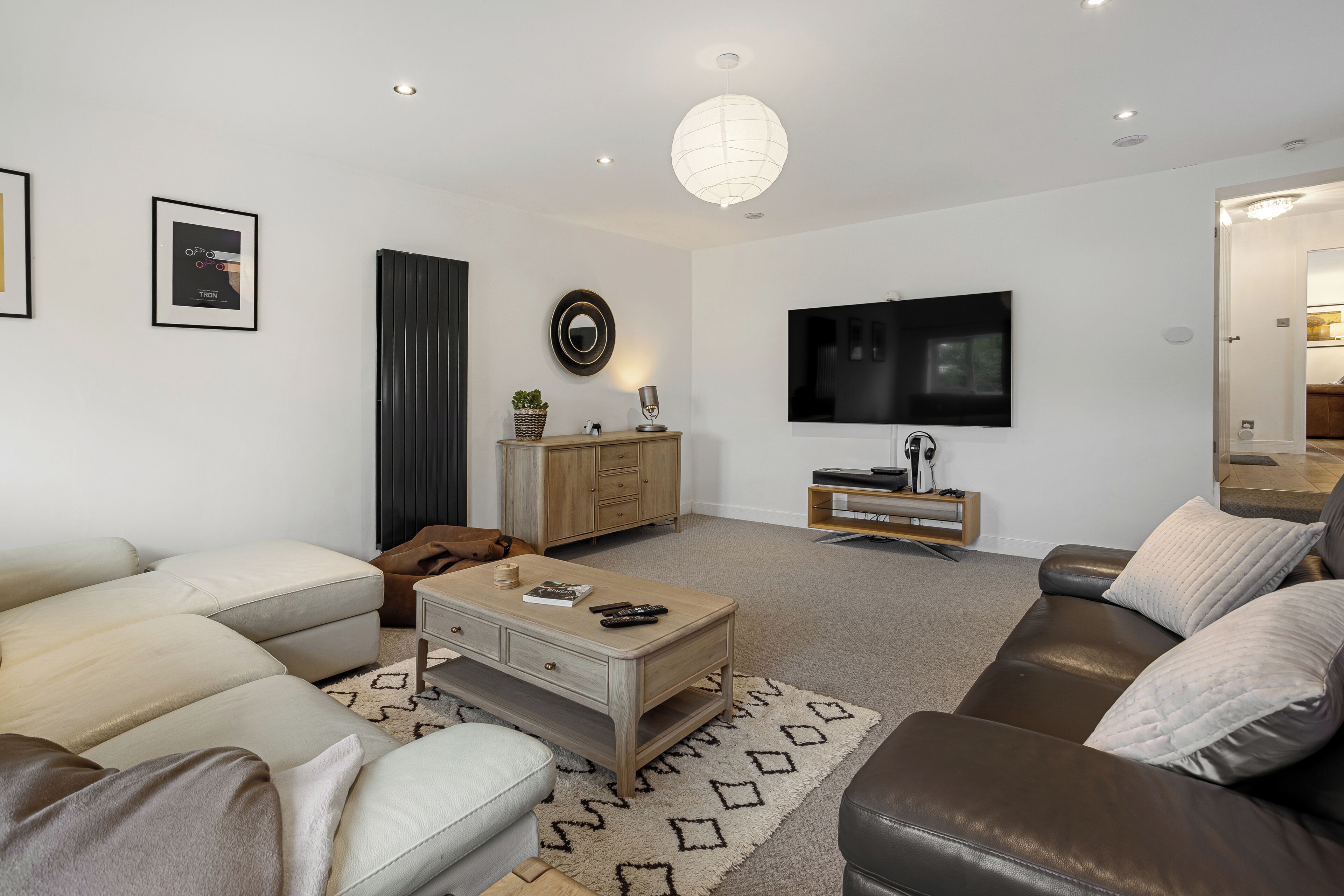 A modern living room with a sofa, coffee table, and TV.