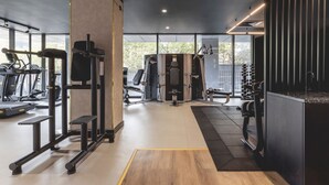 Et moderne fitnesscenter med løbebånd, træningsmaskiner og forskelligt træningsudstyr.