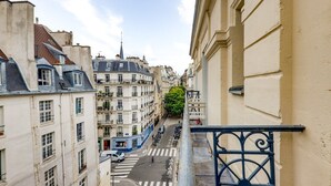 A narrow street with buildings on either side, a pedestrian crossing, and a blue railing. - The cellarman  Pathéon by Mon Mon Petit Faré (Paris)