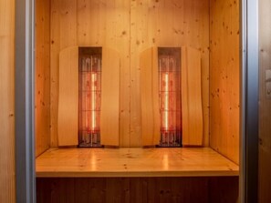 A wooden interior with two vertical panels and a wooden floor.