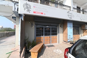 A building with a signboard advertising 'Earthy Palates Cafe and Restaurant'. - Ima Retreat (New Delhi)