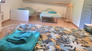 A bedroom with two beds, a desk, a chair, and a wardrobe. - L'Étoile Normande - Country house (Bourgnac)