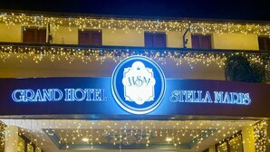 The Grand Hotel Stella Marias entrance with a classic car parked in front.