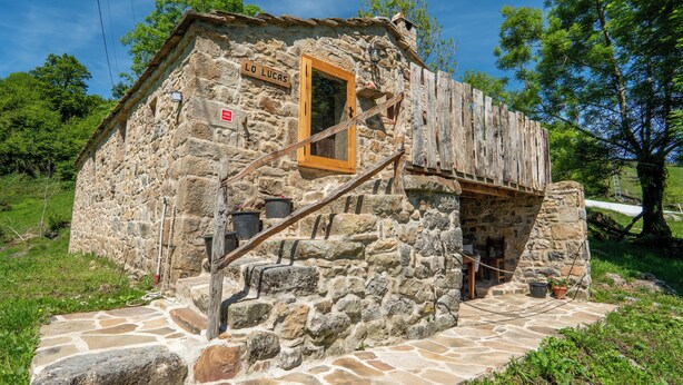 A rustic stone building with a wooden staircase leading to a door marked "LO LUCAS". - Cosy cottage in Los Valles Pasiegos, Cantabria: Lo Lucas 1920 (San Roque de Riomiera)