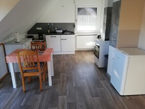Fridge, stovetop, dishwasher, coffee/tea maker