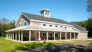 A large, single-story house with a covered porch and a small tower-like structure on the roof. - Remodeled, Washer, Dryer, Mins to Beach & Downtown (Michigan City)