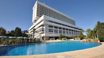 Relax by the pool surrounded by lush greenery and enjoy the hotel's tranquil atmosphere.