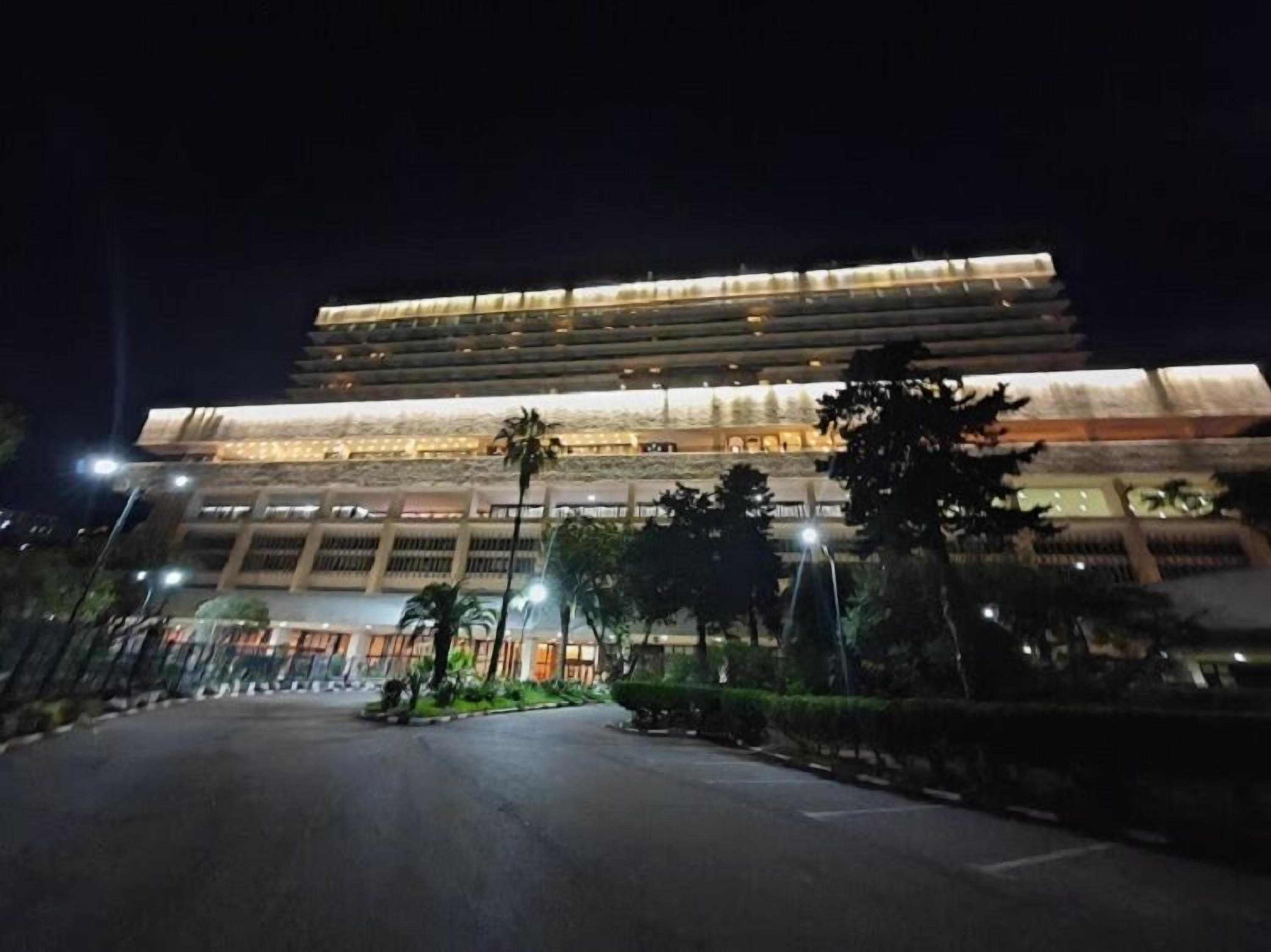 A modern building with multiple floors and a well-lit entrance.