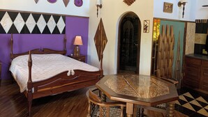 A room with a bed, a table, and a door with a mirror. - Sabi Star Accommodation (Mutare)