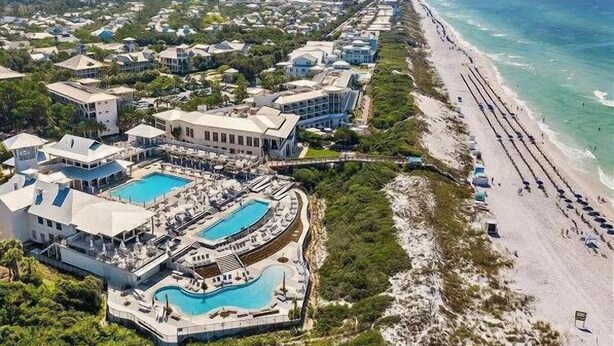 An aerial view of a coastal resort with multiple buildings, a large swimming pool, and a beach. - Step into the blue, stay in the moment at Azure / Golf Cart / 4 Bikes (Santa Rosa Beach)