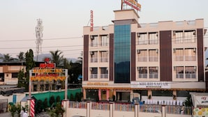 A hotel with multiple floors, balconies, and a prominent sign for Majestic Inn. - MAJESTIC INN (Vasai)