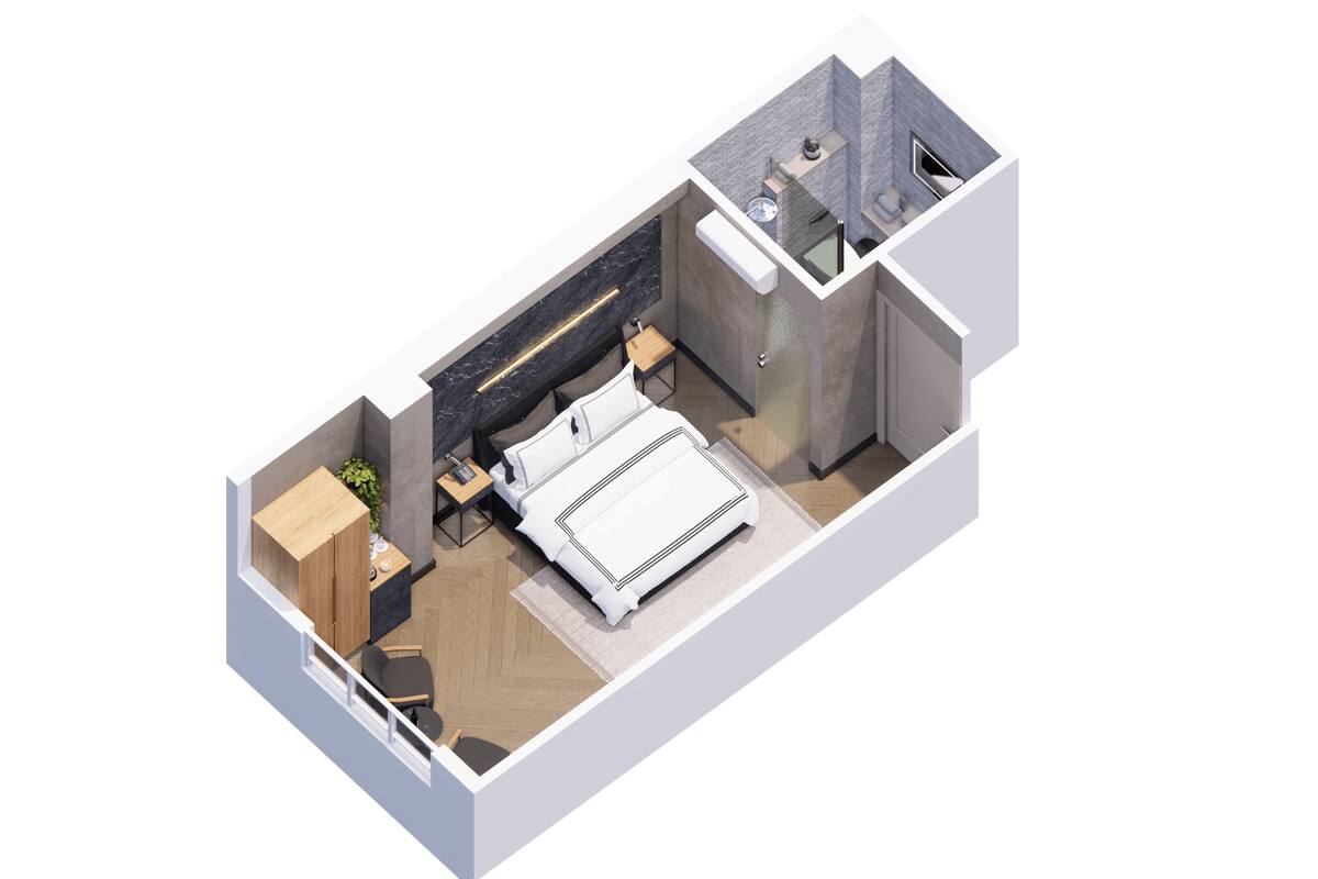 A modern, compact bedroom with a bed, bedside table, and a small seating area.