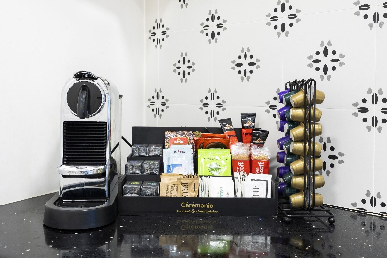 A coffee station with a coffee machine, tea blends, and herbal infusions.