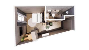 Una cocina moderna con una isla central, un comedor con dos sillas y una pequeña zona de estar con una mesa y sillas.