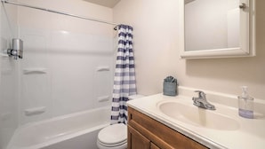 A bathroom with a bathtub, toilet, and sink. - Your Vegas Home From Home! Sleeps 6! (Las Vegas)