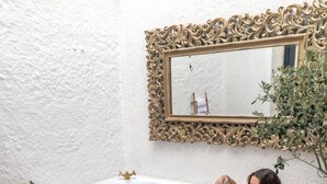 A couple relaxing in a hot tub with a decorative mirror above. -  La Rubina Alacati-Adults Only (Cesme)