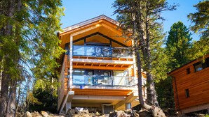A modern multi-story building with a wooden exterior, surrounded by trees. - Chalet in Turrach Near Ski Lift (Stadl-Predlitz)