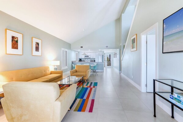 A modern living room with a sofa, a coffee table, and a colorful rug.