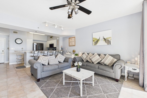 Open concept living area with sleeper sofa TV and balcony access