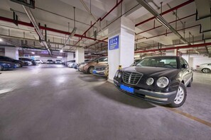 A multi-level underground parking garage with cars parked in designated spaces. - Grace Hotel (Suzhou)