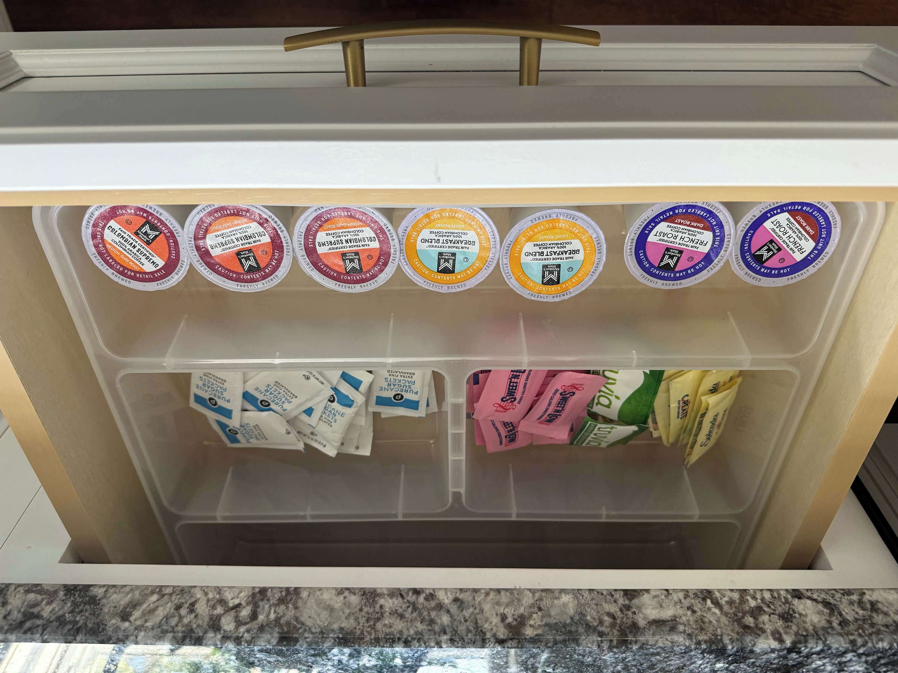 A refrigerator with multiple compartments containing various food items and beverages.