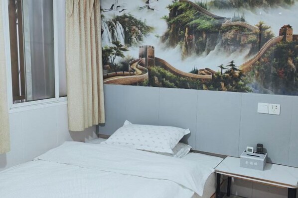 A bedroom with a bed, a nightstand, and a wall mural of a scenic landscape. - Manfulou Hotel (Shanghai Jing'ansi) (Shanghai)