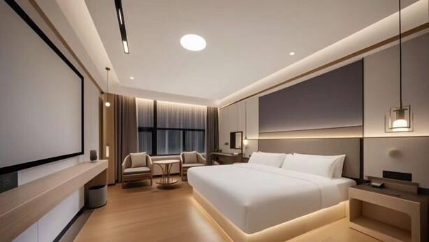 A modern hotel room with a large bed, a desk, a chair, and a TV screen. - Xindi Hotel (Guangzhou Cultural Tourism City Huaguoshan Subway Station) (Guangzhou)