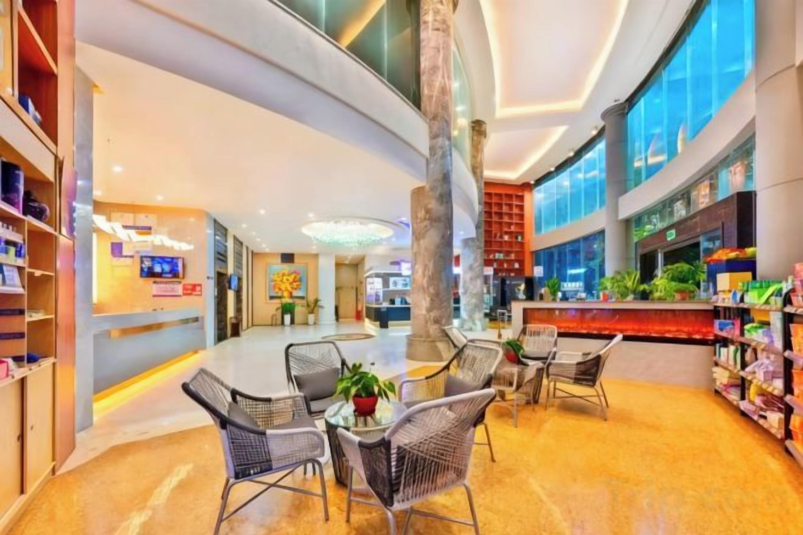 A spacious lobby with a curved ceiling, seating area, and a reception desk.