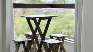 Vista a través de una ventana con una mesa de madera y dos sillas.
