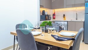 A modern kitchen with a dining area. - Bloomfields 1BR Azizi Gardens Meydan (Dubai)
