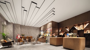 A modern hotel lobby with a reception desk, seating area, and a large abstract painting. - UrCove by Hyatt Aksu Century Square (Aksu)