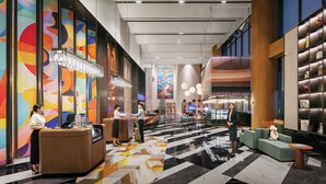 A spacious lobby with a reception desk, seating area, and a large colorful mural. - UrCove by Hyatt Foshan Downtown (Foshan)