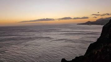 A coastal landscape with a view of the sea and distant land.