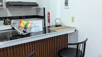 Coffee/tea maker, cleaning supplies, paper towels