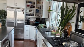 A modern kitchen with stainless steel appliances, a built-in oven, and a gas stove. - Harbor Water View. Downtown. Beaches & waterfront playground +Cape Cod gateway! (Plymouth)
