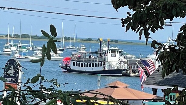 A marina with boats docked, a ferry, and a parking sign. - Harbor Water View. Downtown. Beaches & waterfront playground +Cape Cod gateway! (Plymouth)