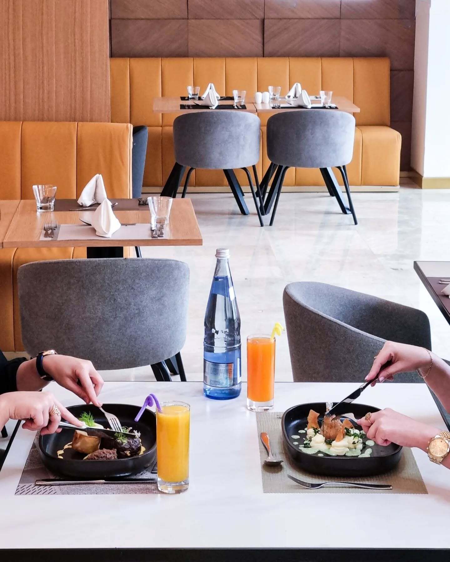 A modern dining area with cushioned seating and a clean, minimalist design.