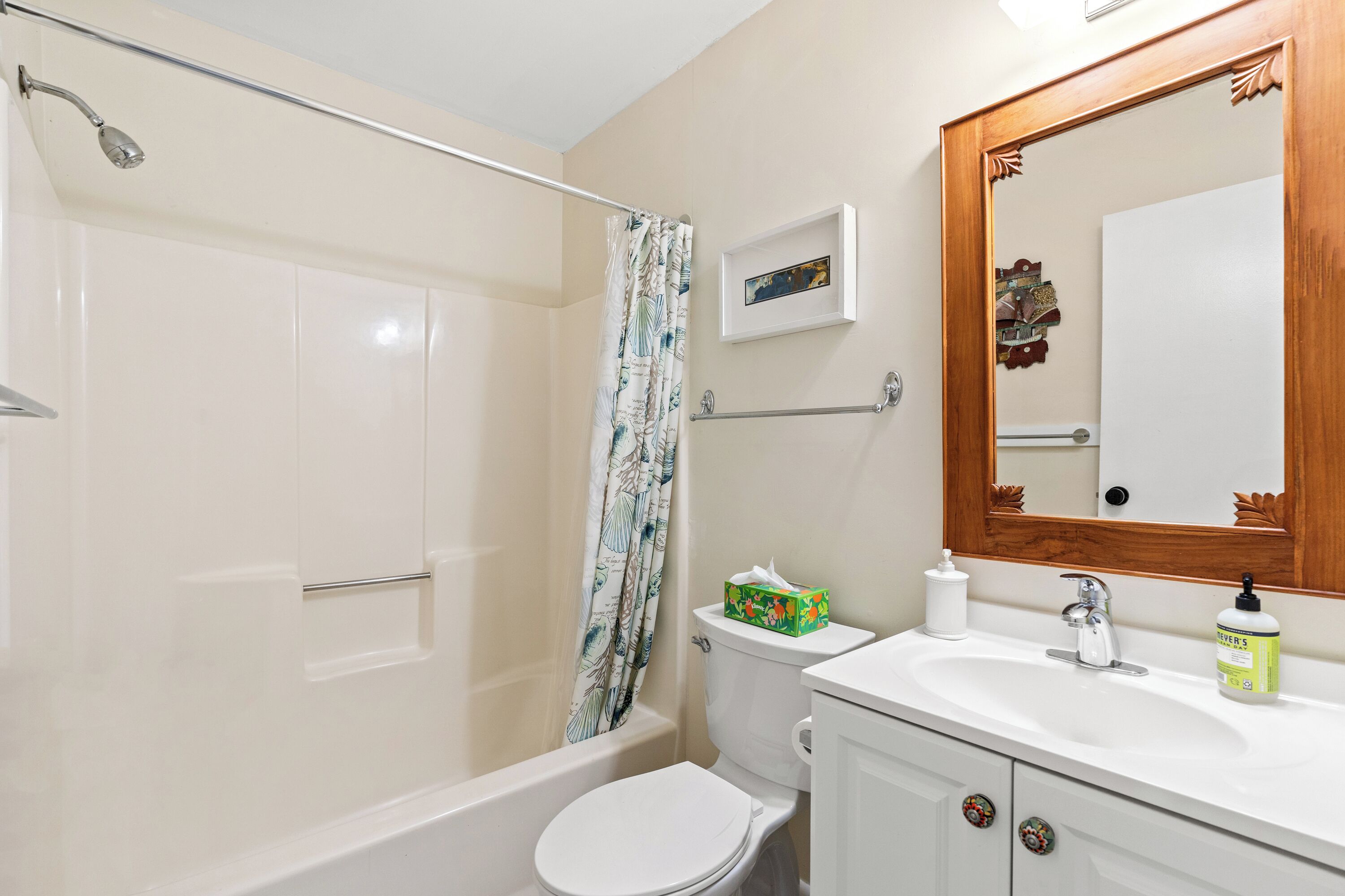 A bathroom with a bathtub, toilet, and sink.