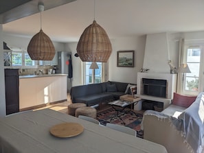 Ein modernes Wohnzimmer mit einer Couch, einem Couchtisch und einem Kamin.