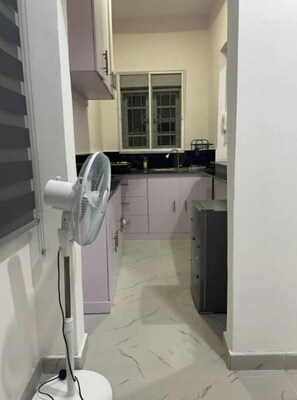 Fridge, electric kettle, cookware/dishes/utensils