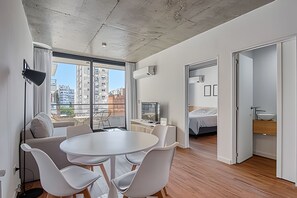 Enjoy a bright and airy living space with a round dining table and city views.