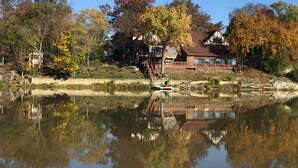 A lakeside property with a house, dock, and reflection in the water. - Spacious room in Tudor home overlooking the Maumee river near Metro Parks. Wifi (Grand Rapids)