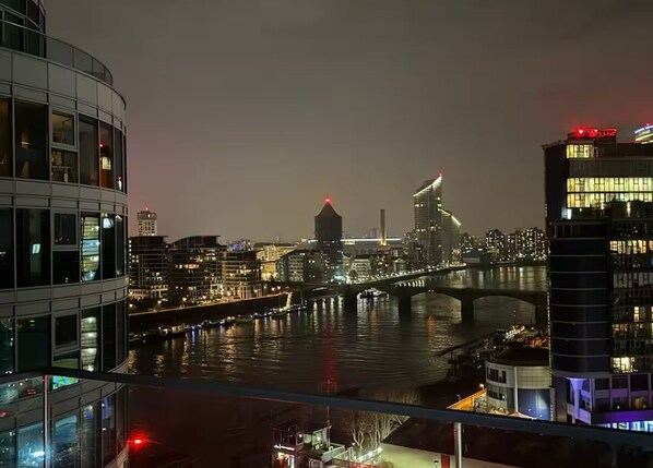 Overlooking the city, this room offers stunning views of a river and a contemporary bridge.