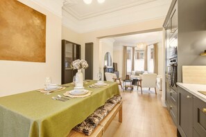 Dining area set for four with open connection to the living room