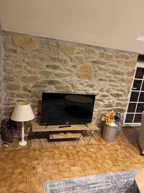 Relax in this inviting living room with a flat-screen TV, comfortable seating, and a beautiful view.