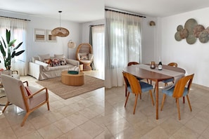 A living room with a sofa, a dining table with chairs, a wicker chair, and a large plant. - Salobre Morro Golf 9 (Maspalomas)