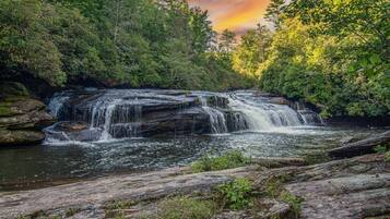 A waterfall surrounded by dense forest.